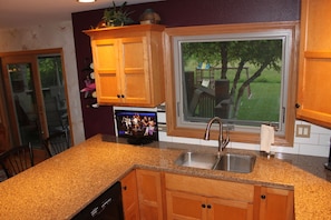 Kitchen including counter TV
