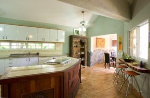 Gourmet kitchen with island and breakfast bar next to dining room
