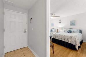 Hallway into spacious bedroom.