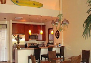 Vaulted ceiling and Hawaiian decor ~ even a surfboard! Seating for 3 at the bar.
