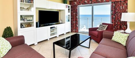 Living room with ocean view and newer curtains & sleeper sofa for extra guests!