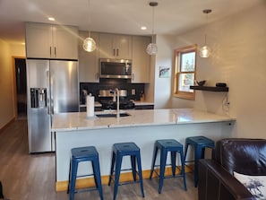 Newly remodeled kitchen with quartz countertops, ss appliances, fully stocked