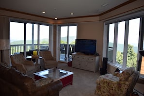 The living room has expansive views and a 55" Ultra HiDef TV.