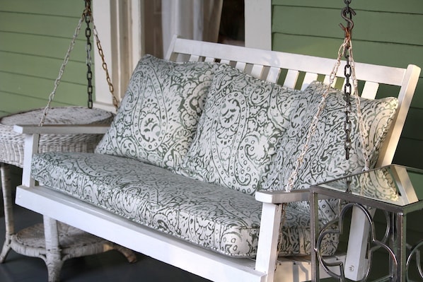 Enjoy a cup of coffee on the front porch swing