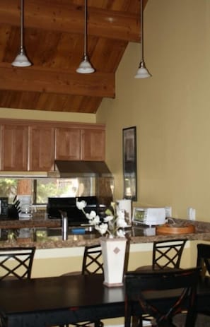 Vaulted ceiling, pendant lighting in remodeled kitchen