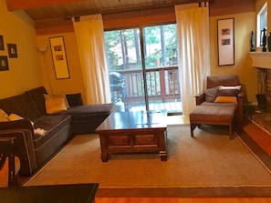 Living area and balcony with forest views