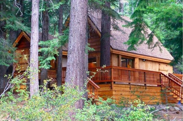 Front view in Summer.  Pine trees provide privacy from quiet Ward Creek Road