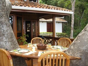 Enjoy dining on the large tree house deck (detached bodega behind)