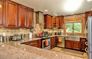 Gourmet kitchen w/granite counters & high-end stainless steel appliances
