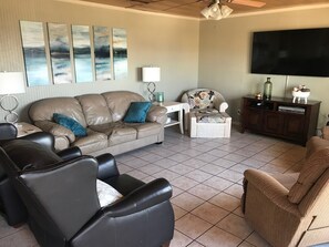 First level living area includes big screen television and comfortable seating