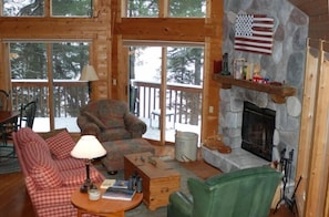 Living room w/ wood burning fireplace/ Lake view