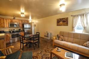 Living area looking at kitchen/dining area.  Futon folds out into a full bed.