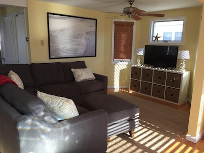 Sunny living room with new furniture and TV
