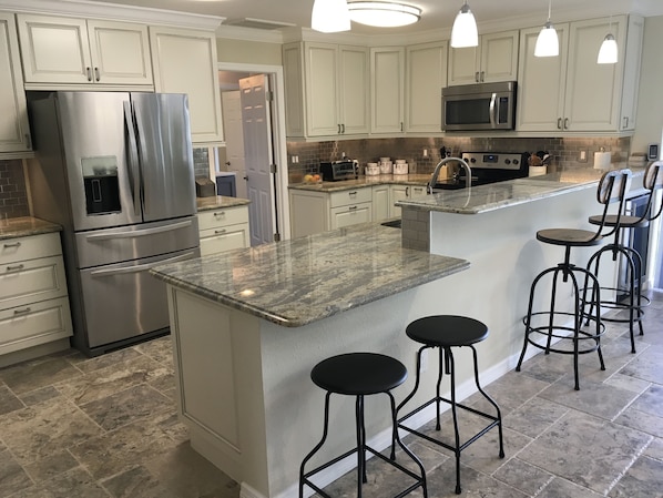 Beautiful, new kitchen featuring tile floor, granite countertops and much more!