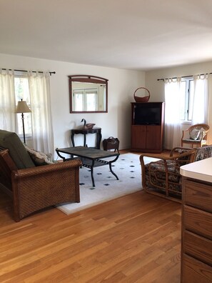 Living room opens onto deck; sofa unfolds to full size bed.