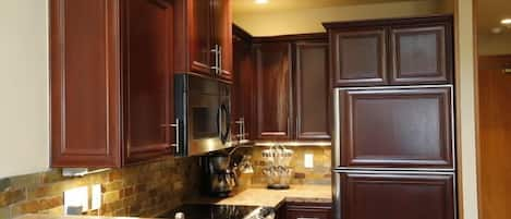 Stunning designer kitchen comes fully equipped including 10 sets of dishes.