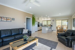 Modern spacious living, dining and kitchen area with full cooking facilities.