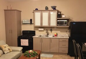 Unit A Kitchen. Full size appliances and double sink. Pots, pans, dishes etc...