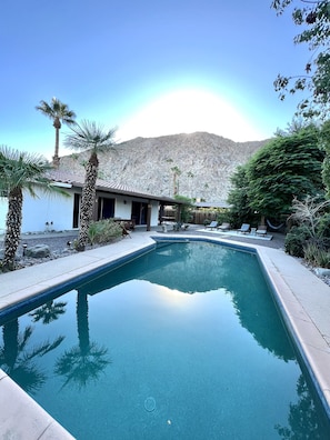 Large pool area with stunning mountain view backdrop.