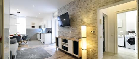 Living area with kitchen and view to the bathrooms