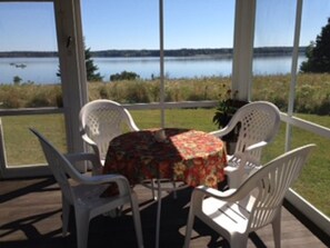 Screen porch looking out at water.