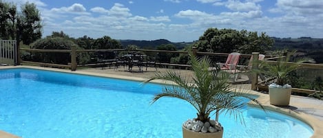 large pool with stunning views over the countryside.