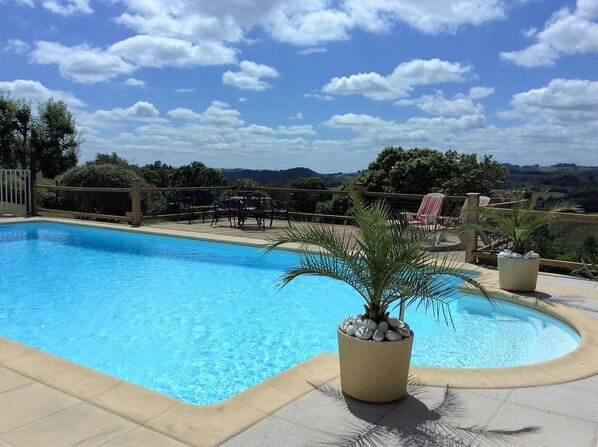 large pool with stunning views over the countryside.