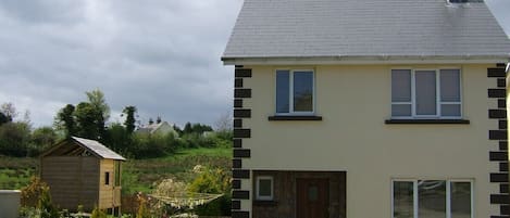 Front of house/ kids playhouse in rear garden