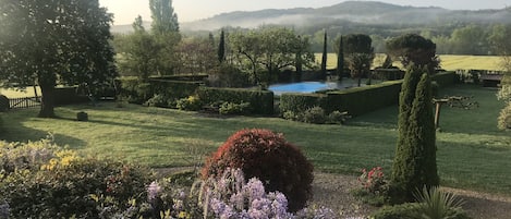 View from bedroom window of garden and pool