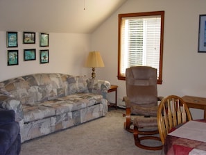 Living room has a queen sofa bed.  HDTV with cable and DVR.