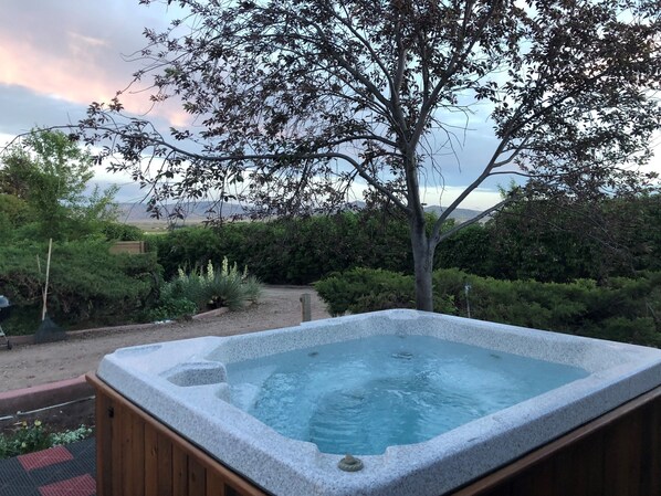 The Hot tub on the front porch has beautiful views of the surrounding areas.