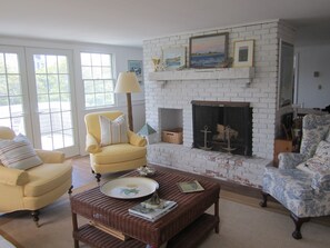 Living Room with Fireplace, outside sitting area with table and chairs