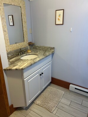 Downstairs bathroom granite countertops & large stand up shower. 