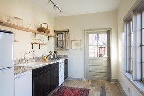 Mae's kitchen with gas range and dishwasher.