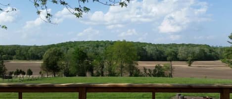 Relax on the deck with views that overlook farmland and forest.