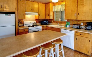 Fully equipped kitchen with full size refrigerator, dishwasher, stove and oven, coffee maker and toaster