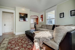 Living Room off the kitchen and deck overlooking the gardens. 