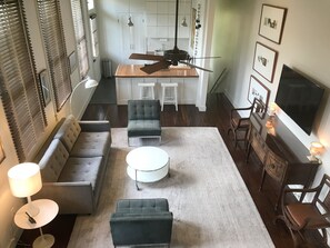 View of living room and kitchen from 3rd floor stairs.