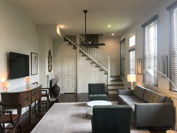 View of living room to stairs leading to 3rd floor bedroom.