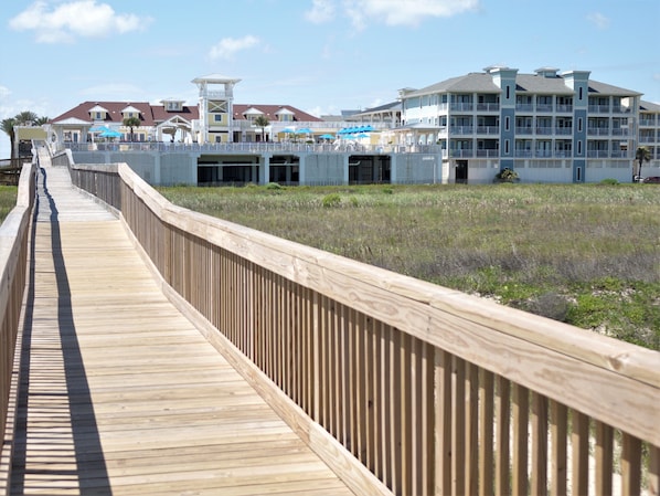 Boardwalk to the beach. Your condo building on the right. Beach Club on the left.