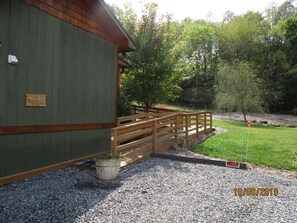 Landscaped access ramp right next to two parking spaces.  