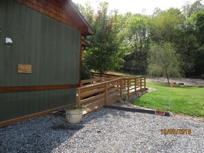 Landscaped access ramp right next to two parking spaces.