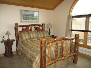 Large bedroom w/pine vaulted ceilings, large windows w/mtn views, private deck.