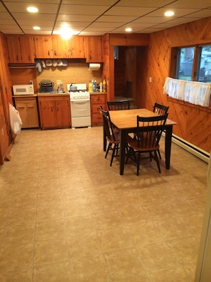 Large fully stocked eat-in kitchen with new flooring and lighting