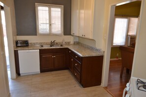 Kitchen with dishwasher, toaster oven, Microwave, stove, tall cabinets