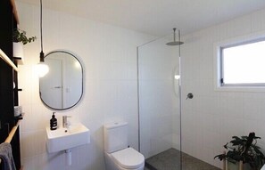 New upstairs bathroom with shower, bath, toilet and sink.