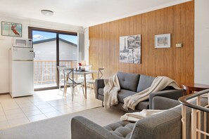 A spacious living area drenched with morning sun.