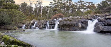 Waterfall in front of the deck at Falls River Accommodation