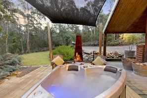 Outdoor spa and fireplace.