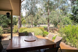 Savor open-air dining on a spacious deck with a massive table.